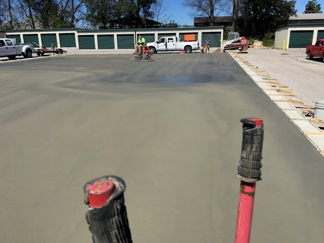 Freshly poured concrete slab with control joints and finished edges at commercial property