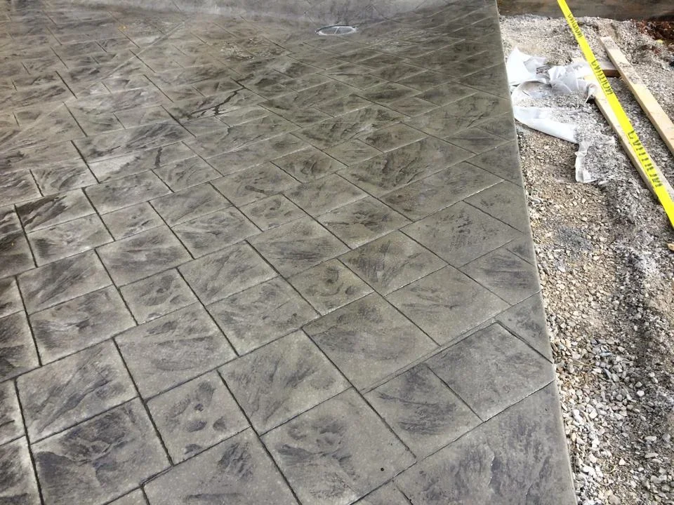 Diagonal stamped concrete patio with slate pattern texture and gray coloring