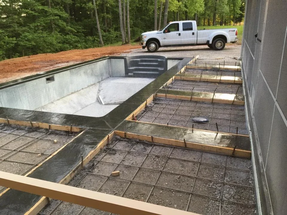 In-ground pool foundation with rebar reinforcement and concrete forms ready for pour